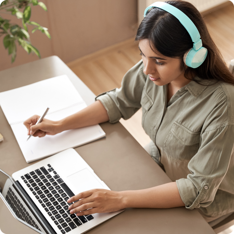 Student preparing for IELTS with laptop and headphones